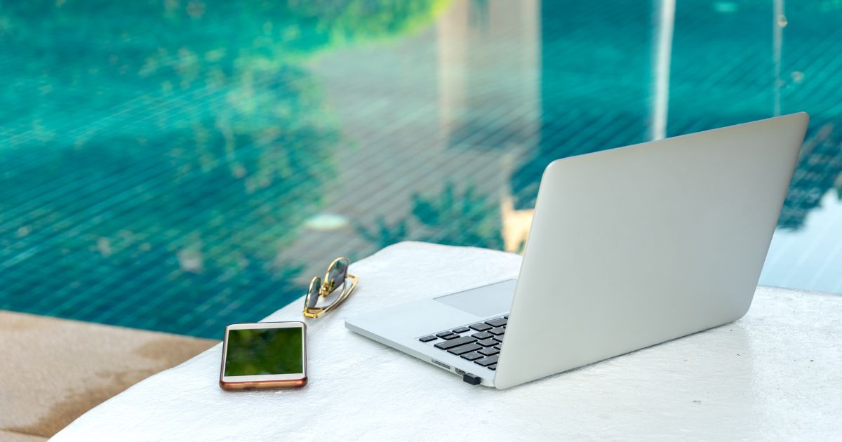 UK expat working remotely by a pool — resources, guides and insights for overseas pension planning and retirement abroad